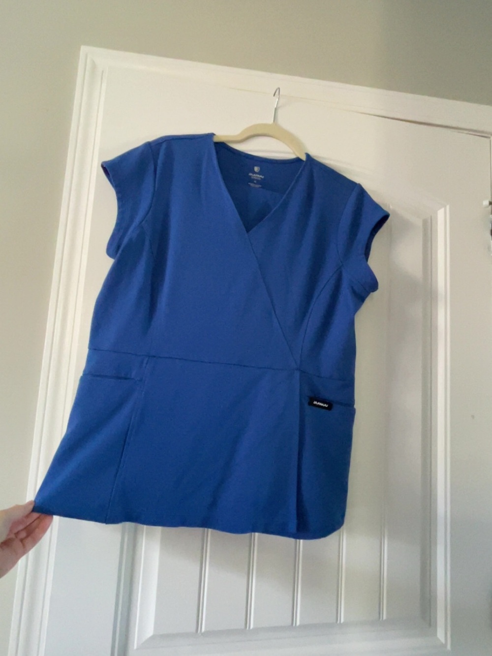 Jaanuu Cobalt Blue Crossover V-Neck Scrub Top with petite pants.